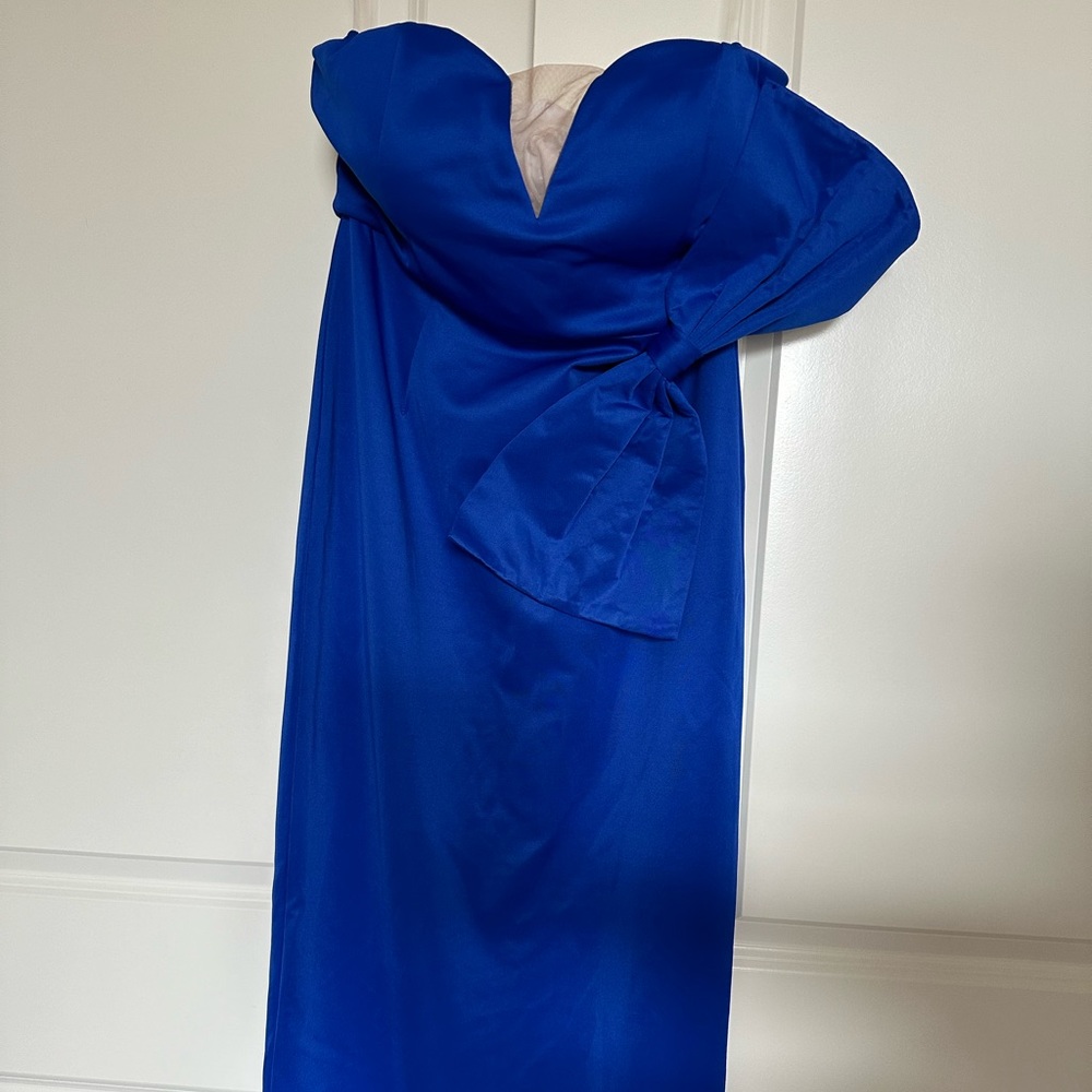 Strapless semi formal dress with zipper back and bow on front.
